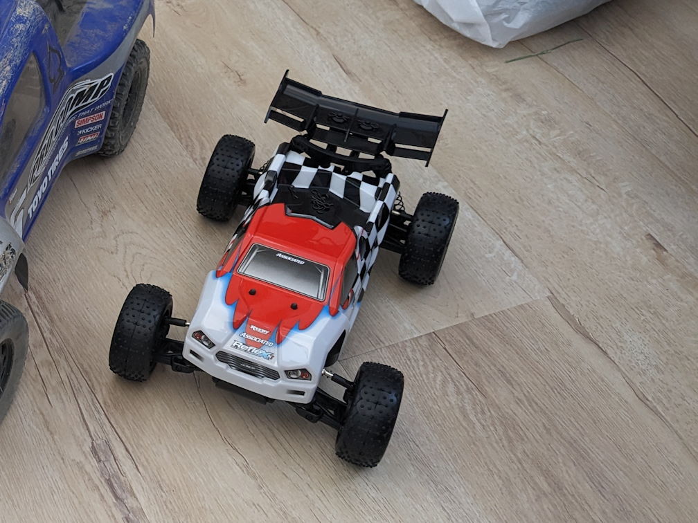 a team associated Reflex 14T rc car with stock body