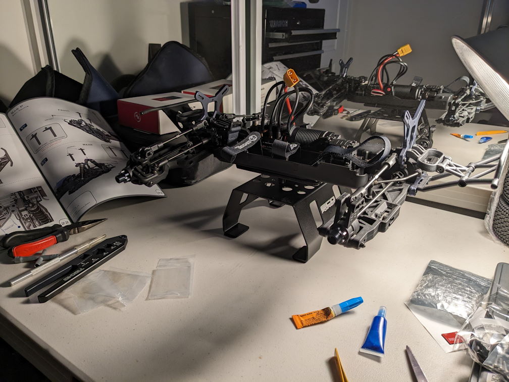 an MT410 rc car on a car stand in progress with electronics but no shocks