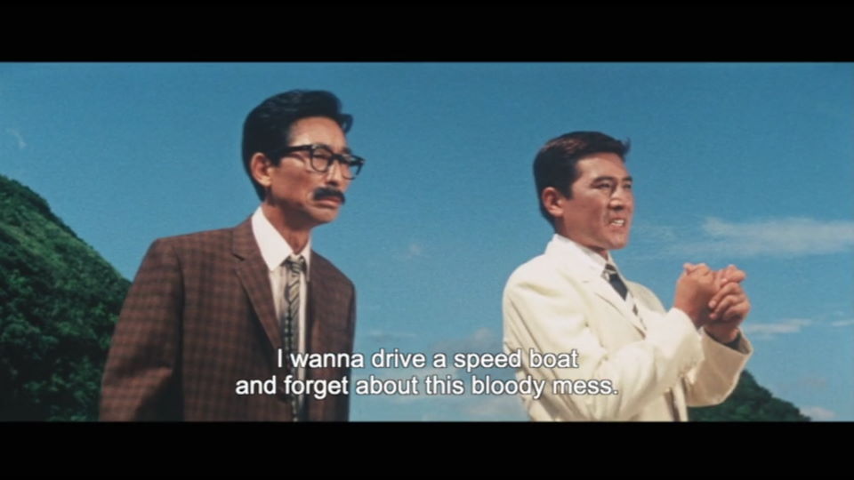 from the Japanese Bond spoof Ironfinger. Two men stand on the shore, one in glasses. The one without glasses is saying I wanna drive a speedboat and forget about this whole bloody mess