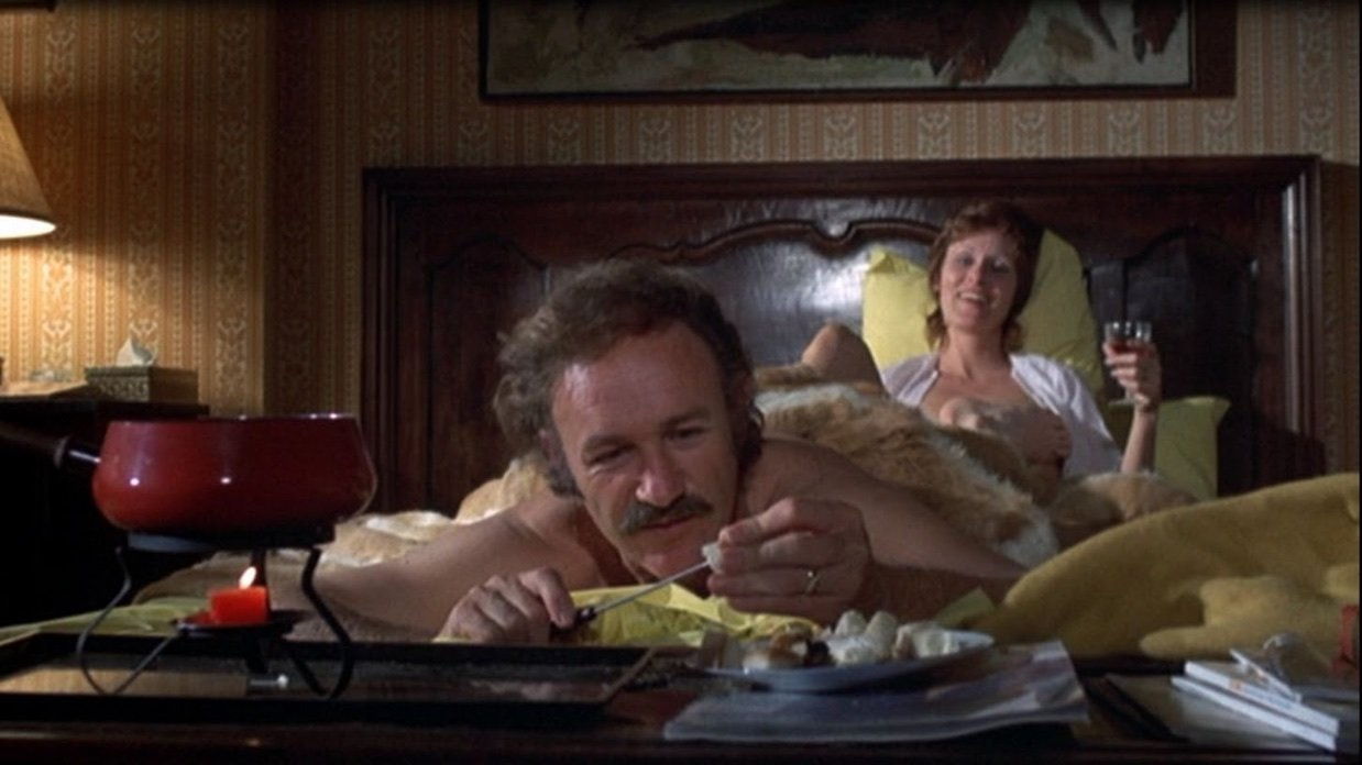 gene hackman as harry moseby in night moves, eating fondue in bed, his estranged wife behind him. post-coital chill vibes