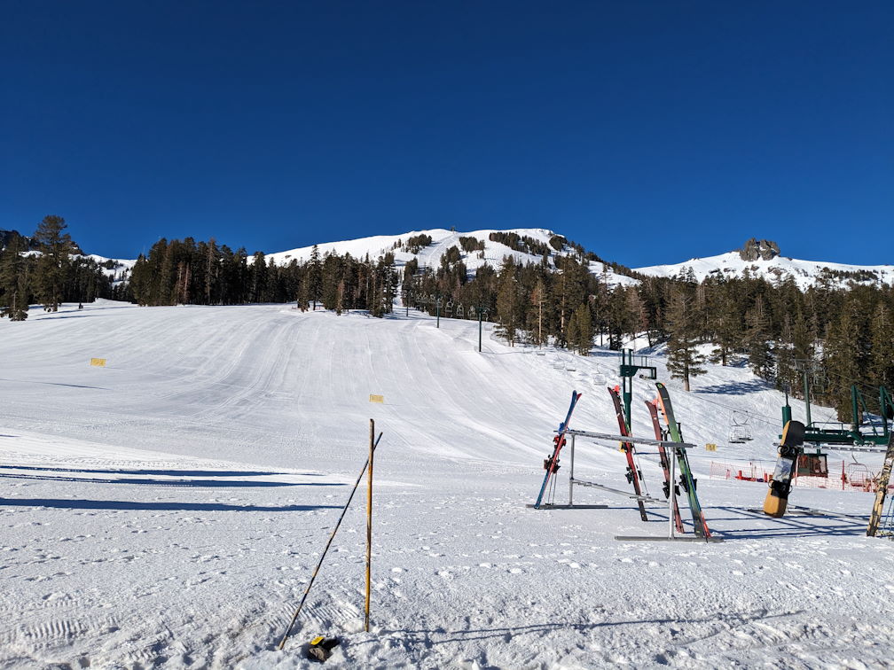an empty ski slope with morning light and clear skies